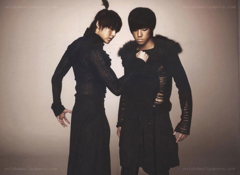 two men in black outfits