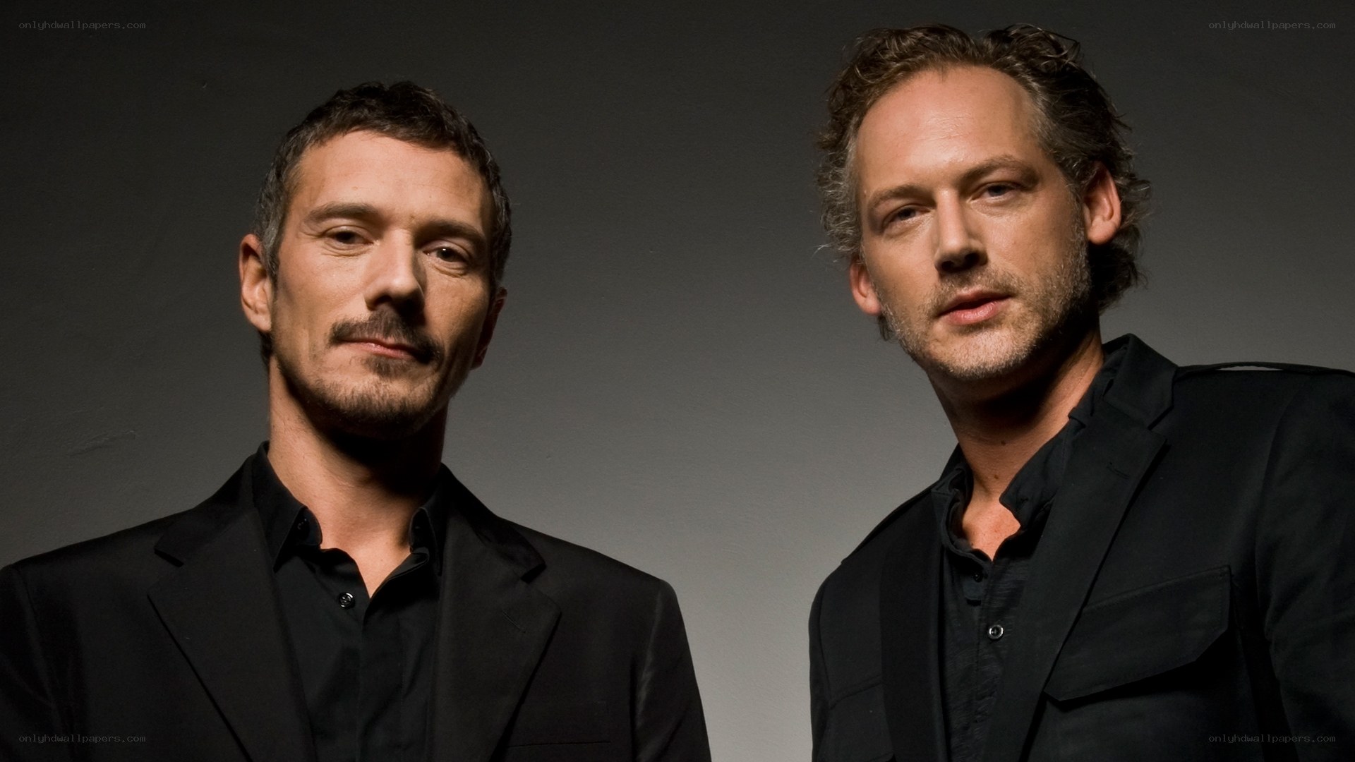two men in black suits