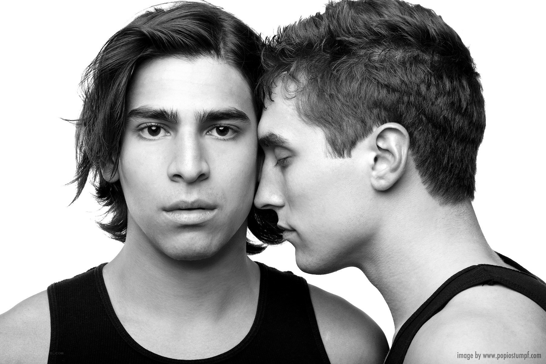 two men in black tank tops