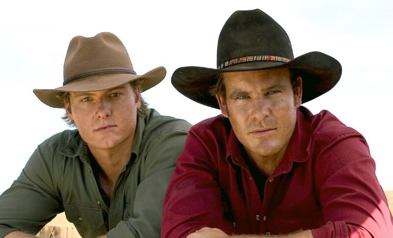 Two Men in Cowboy Hats — Brown, Serious