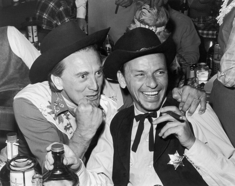 Two men in cowboy hats laughing