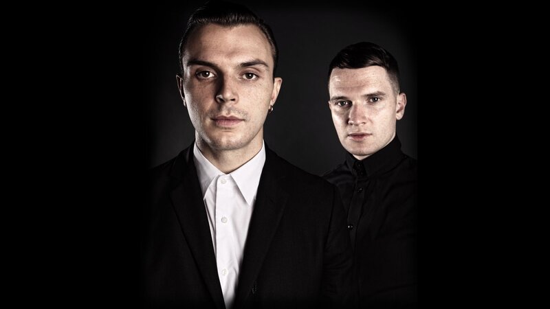 Two Men in Dark Clothing — Black, Serious