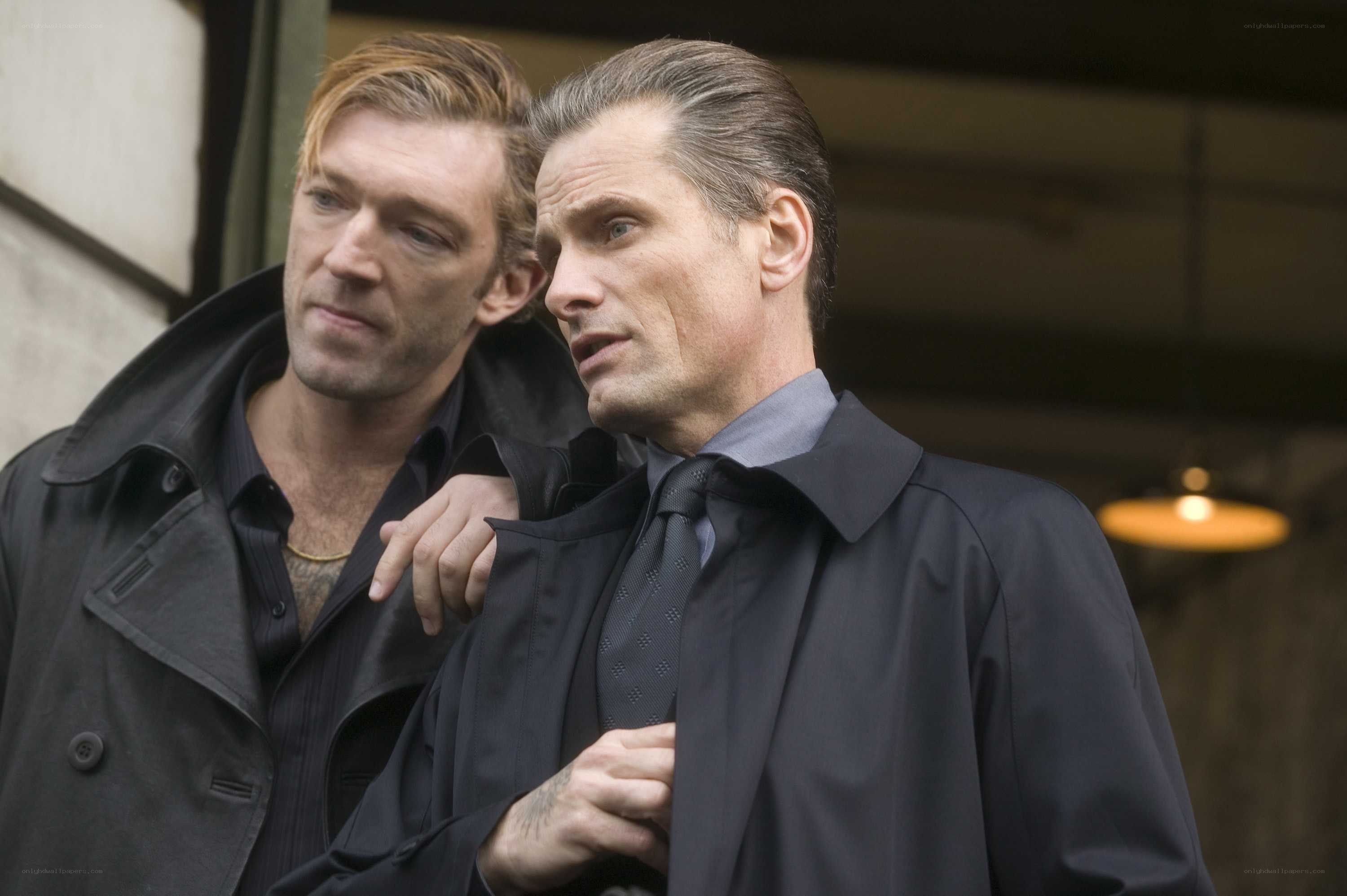 Two men in dark coats