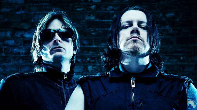 two men in dark vests