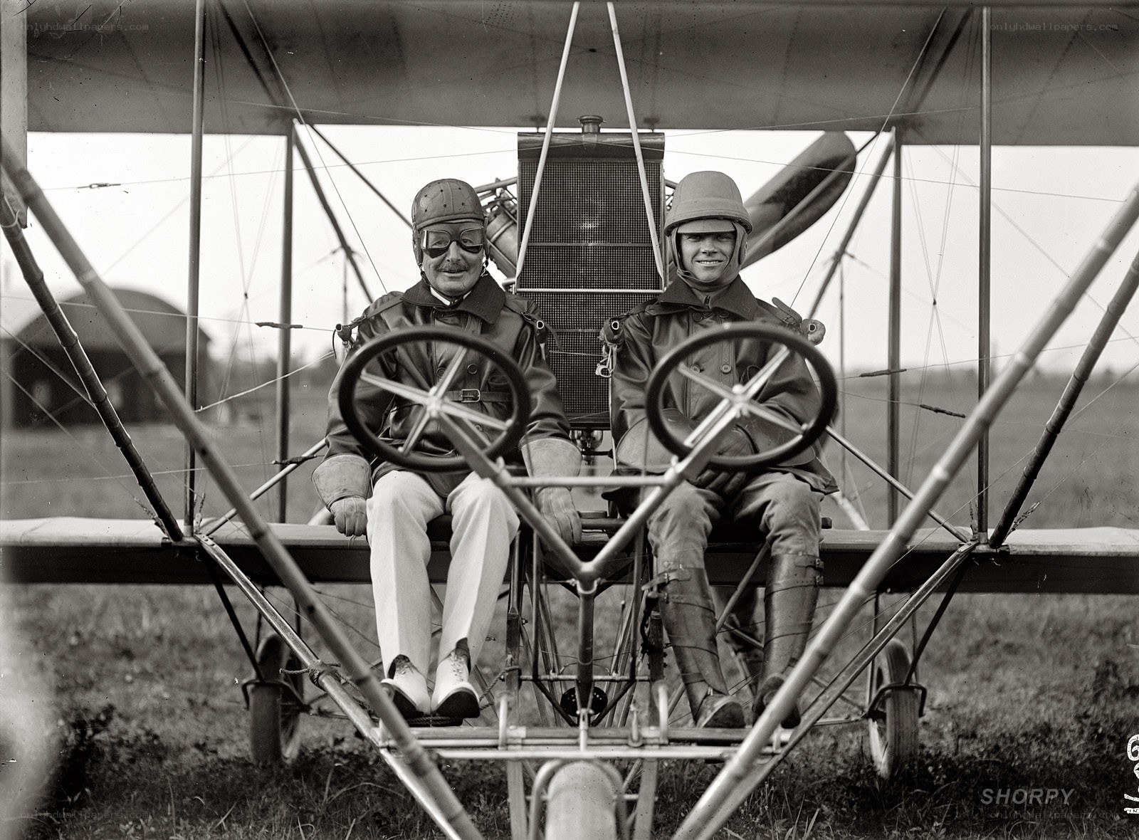 Two men in early airplane