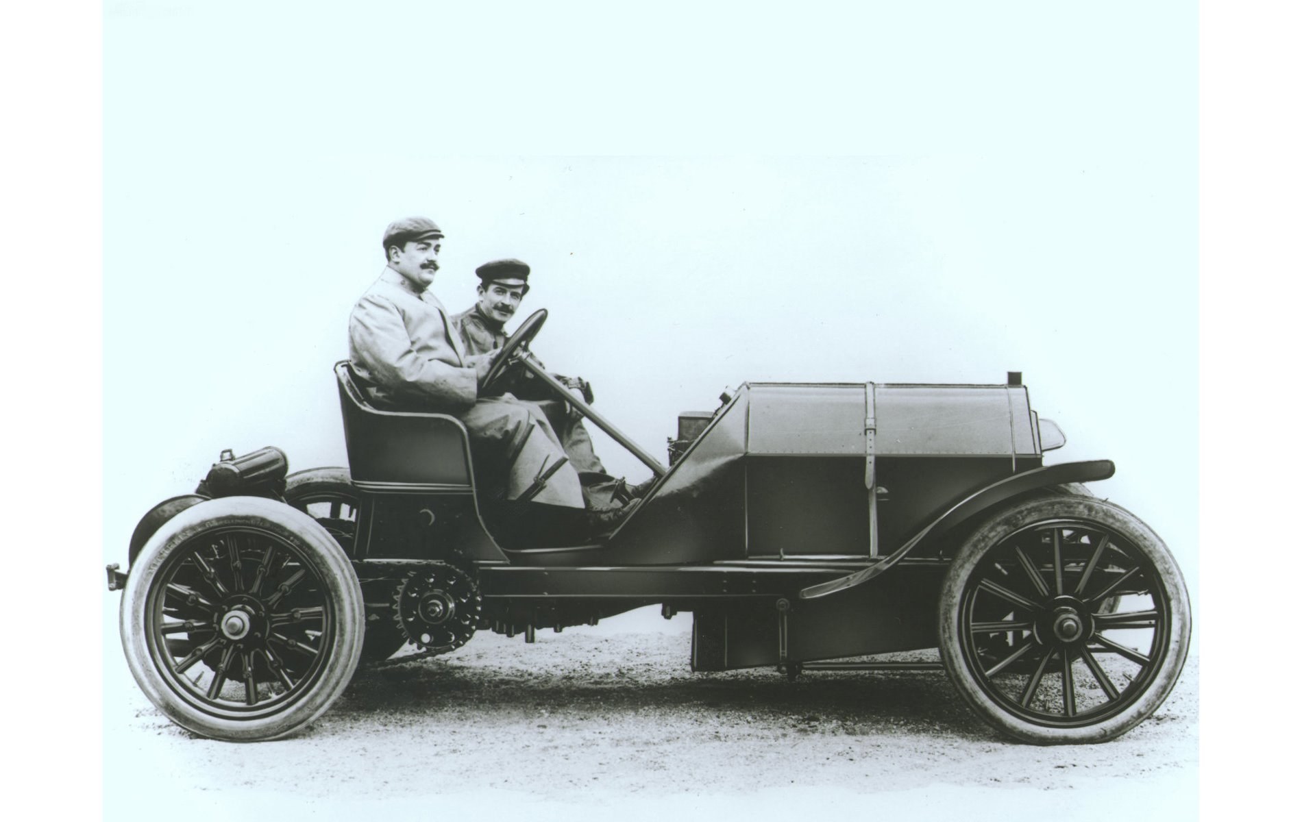 Two men in early automobile