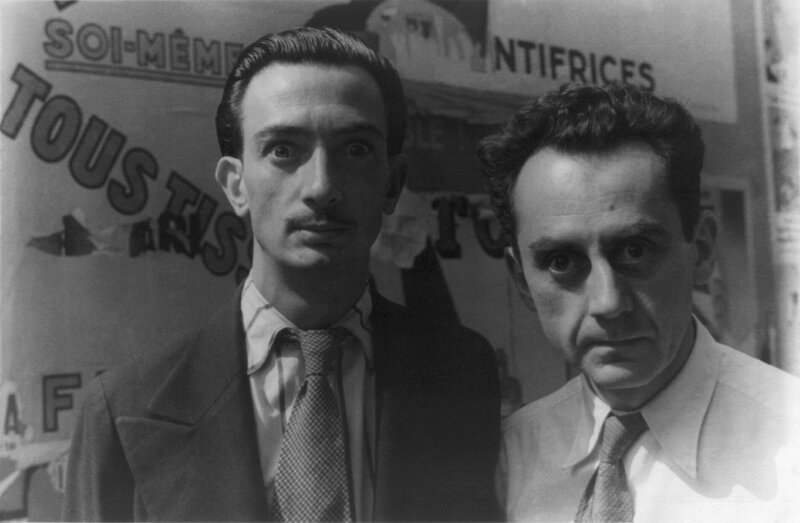 Two men in front of a poster