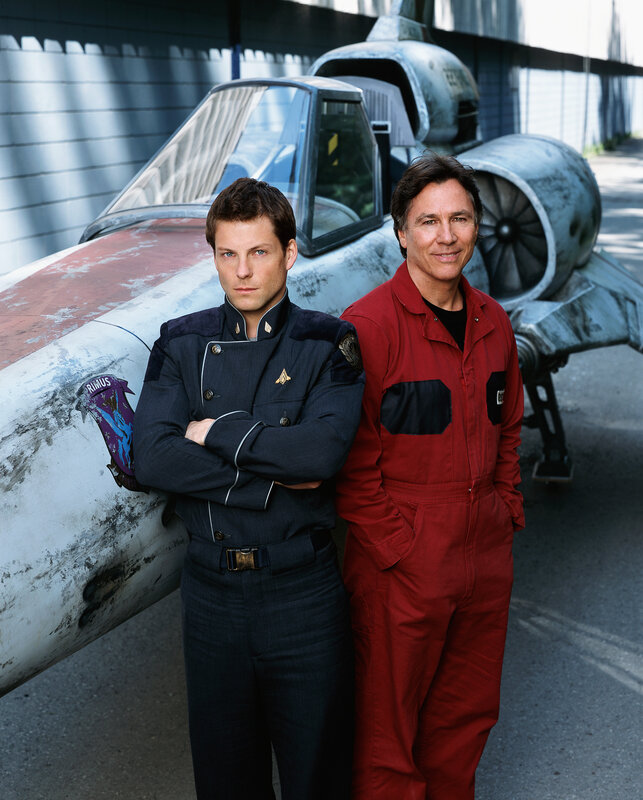 Two men in front of a spaceship