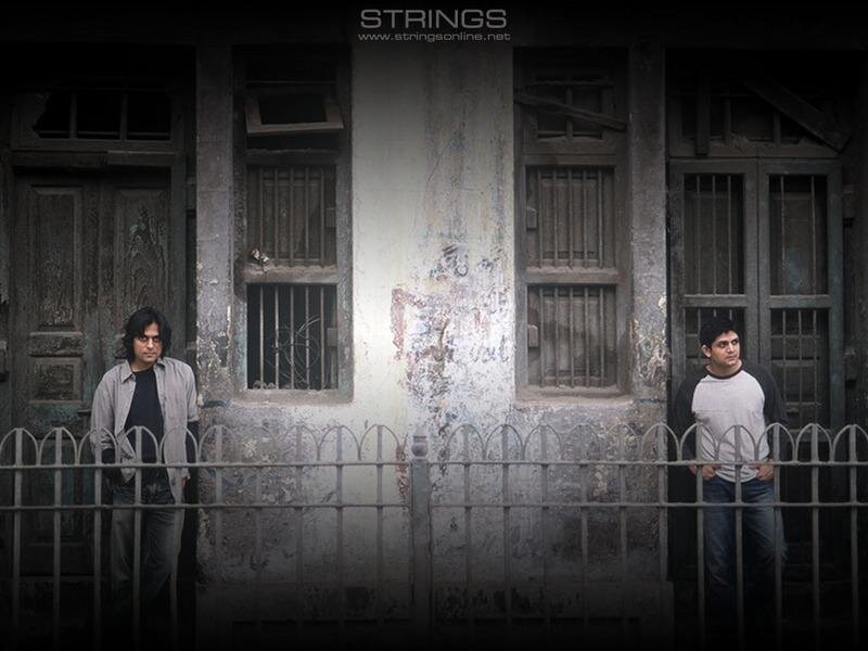 two men in front of old building