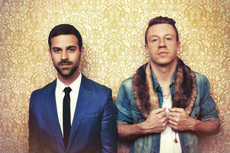 Two Men in Front of Wallpaper