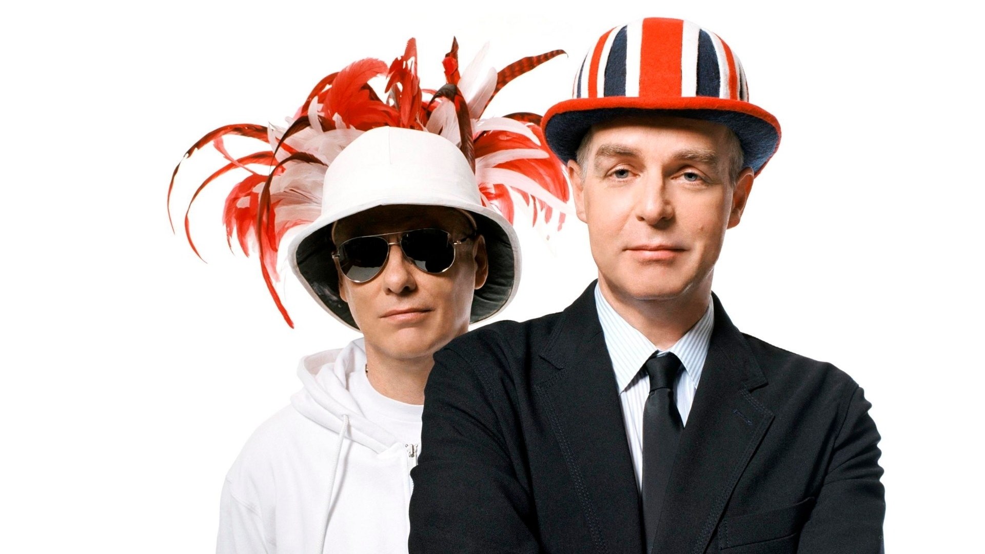 Two men in hats and sunglasses