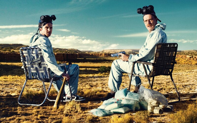 Two men in hazmat suits in desert