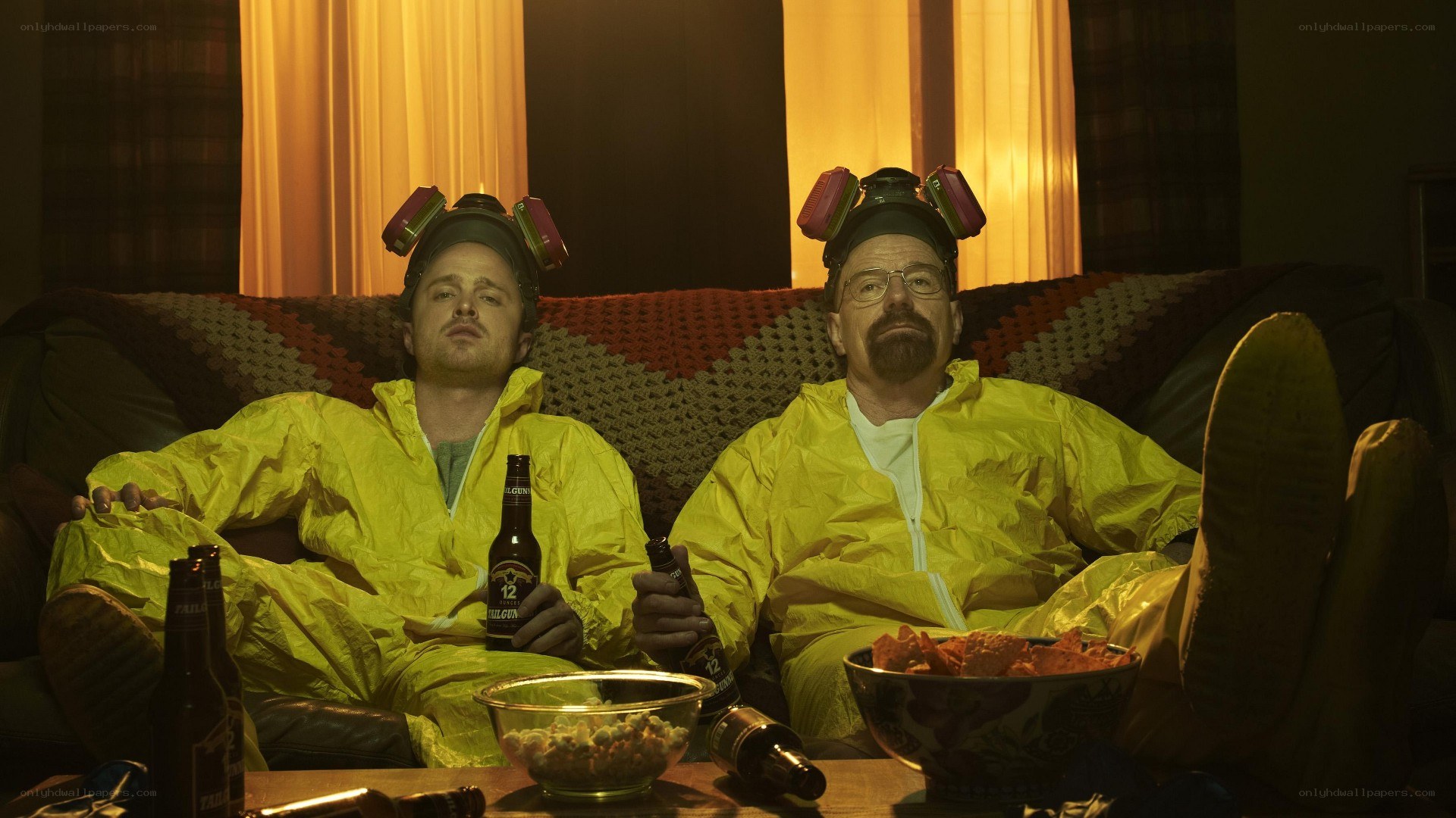Two men in hazmat suits on a couch