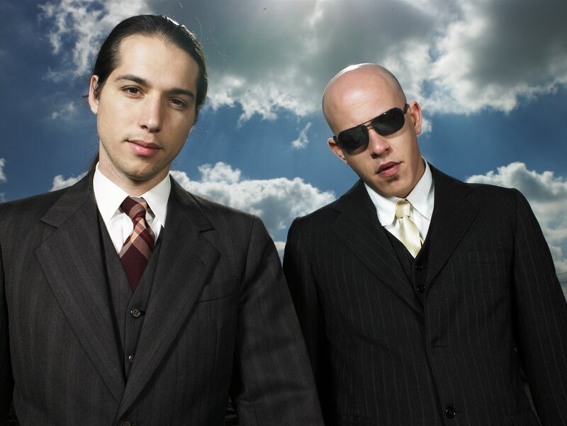 two men in suits against sky