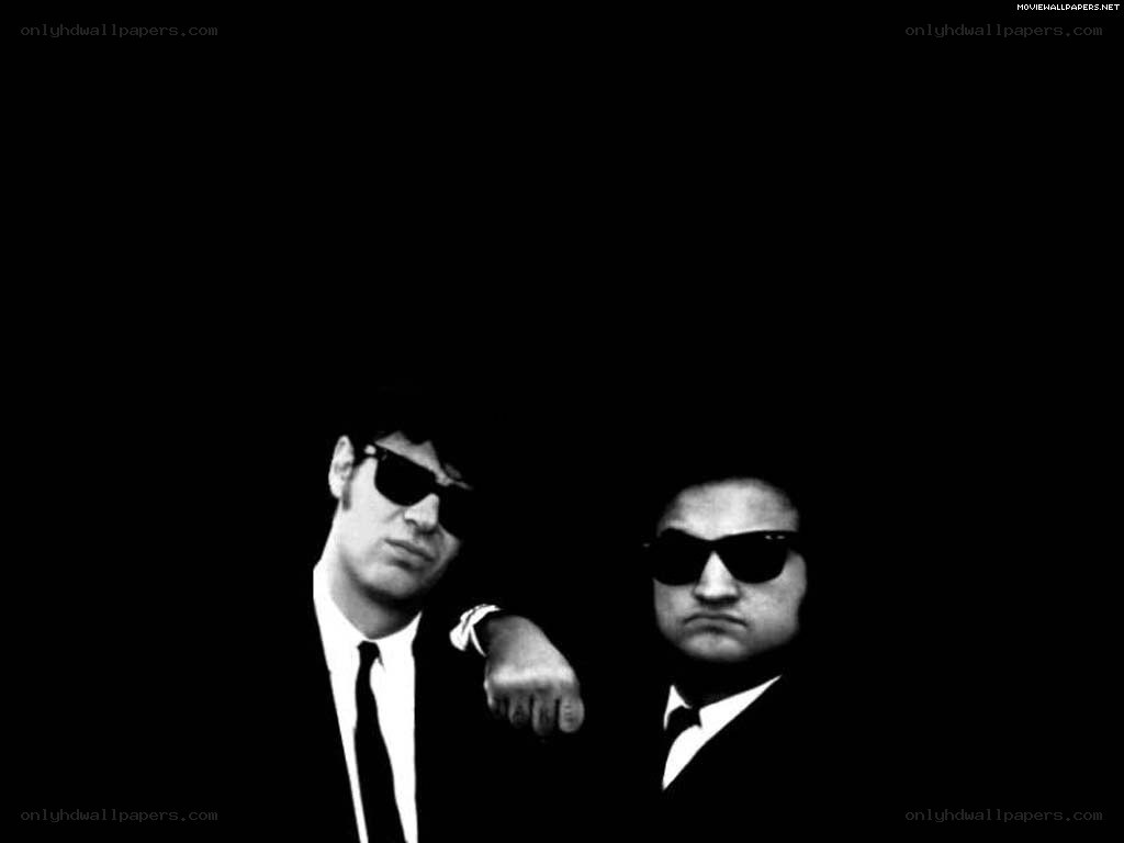 two men in suits and sunglasses