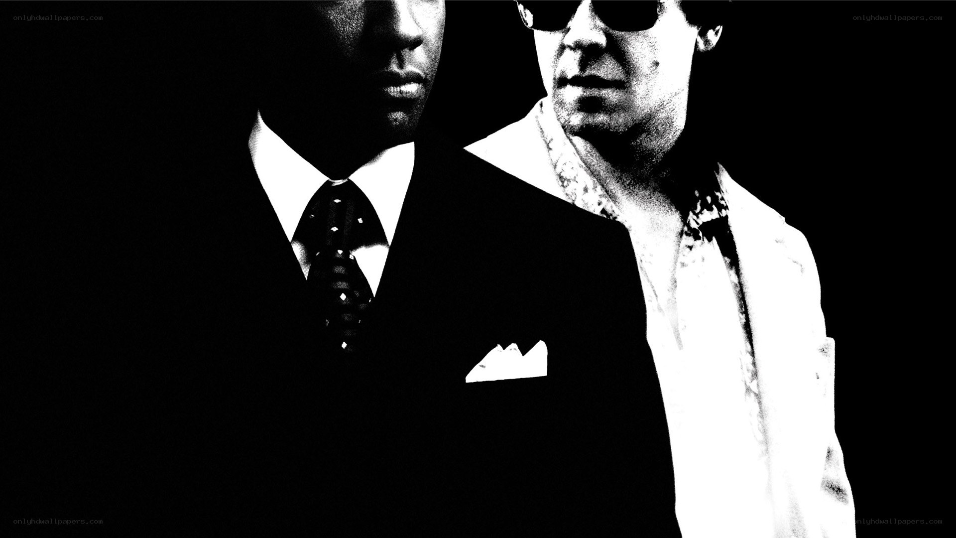 two men in suits and sunglasses