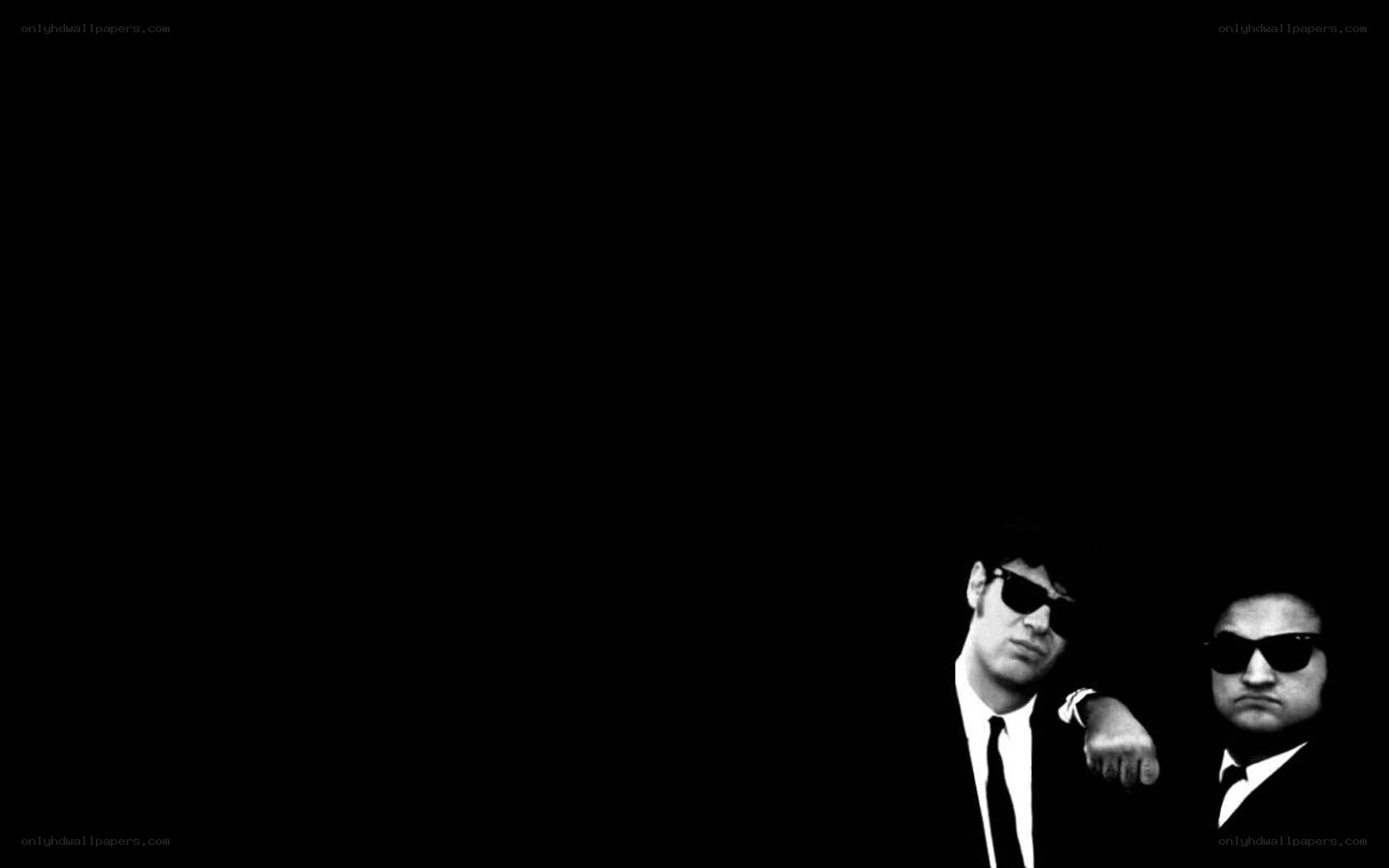 two men in suits and sunglasses
