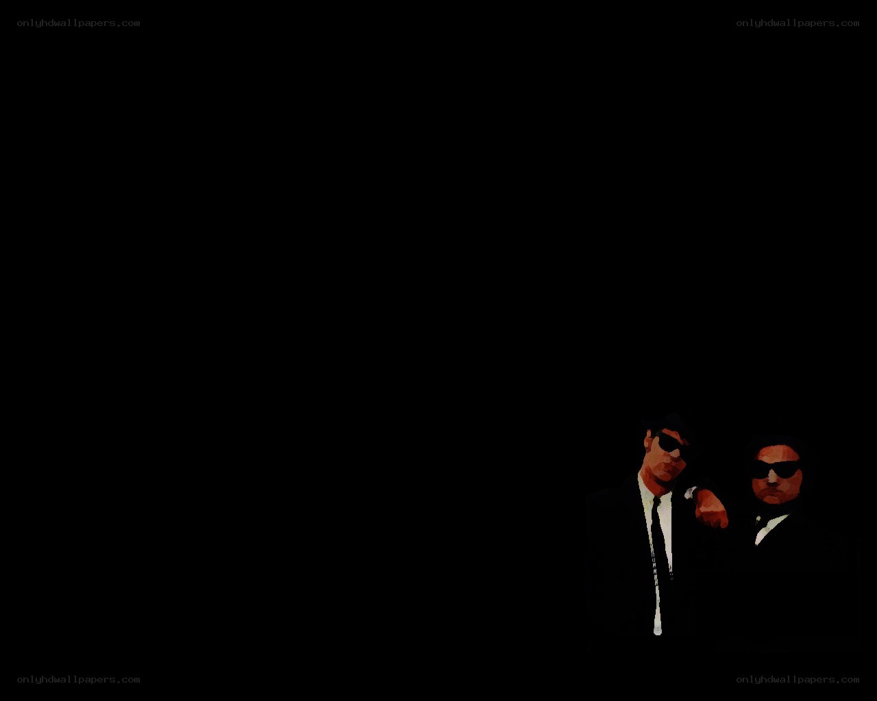 two men in suits and sunglasses