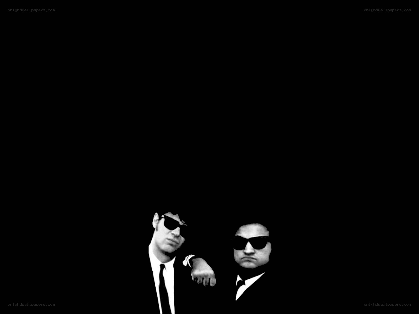 two men in suits and sunglasses