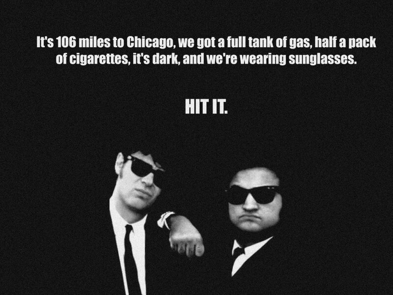 two men in suits and sunglasses