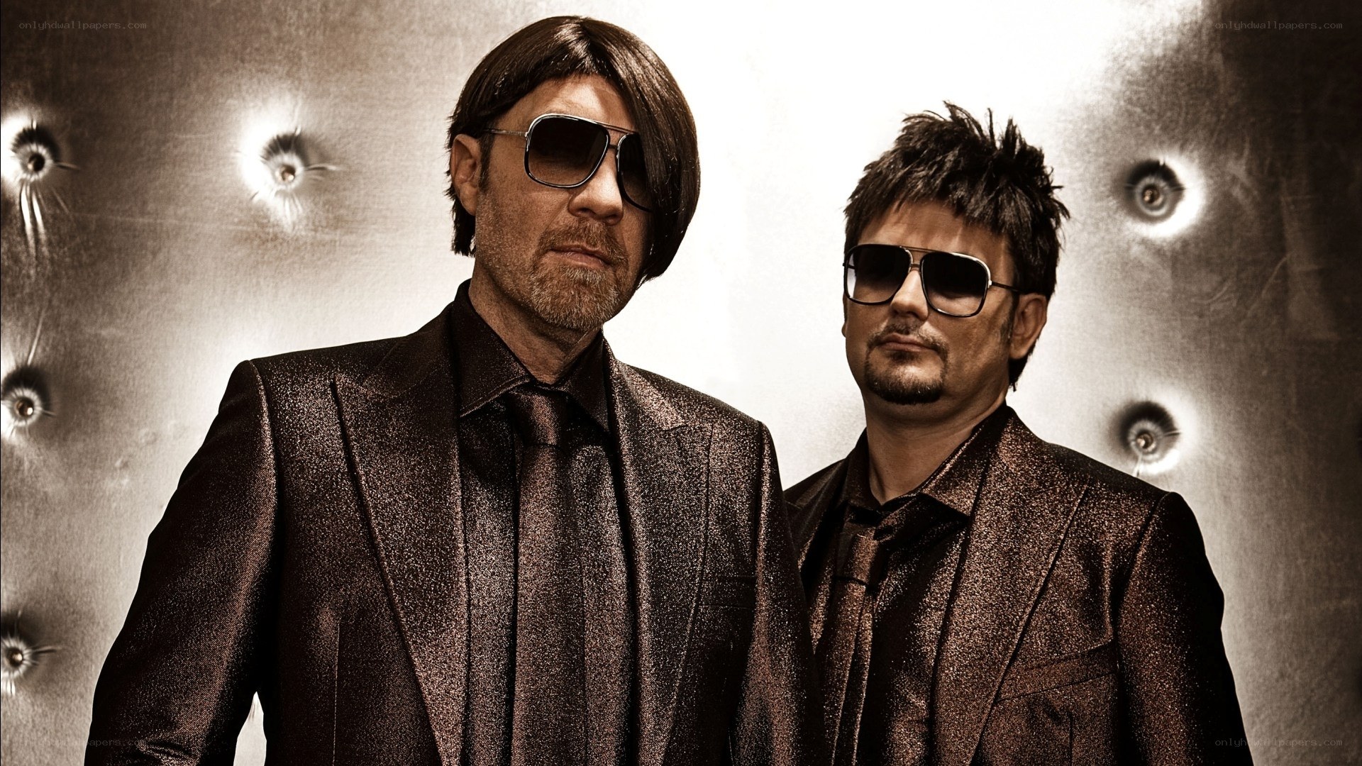two men in suits and sunglasses