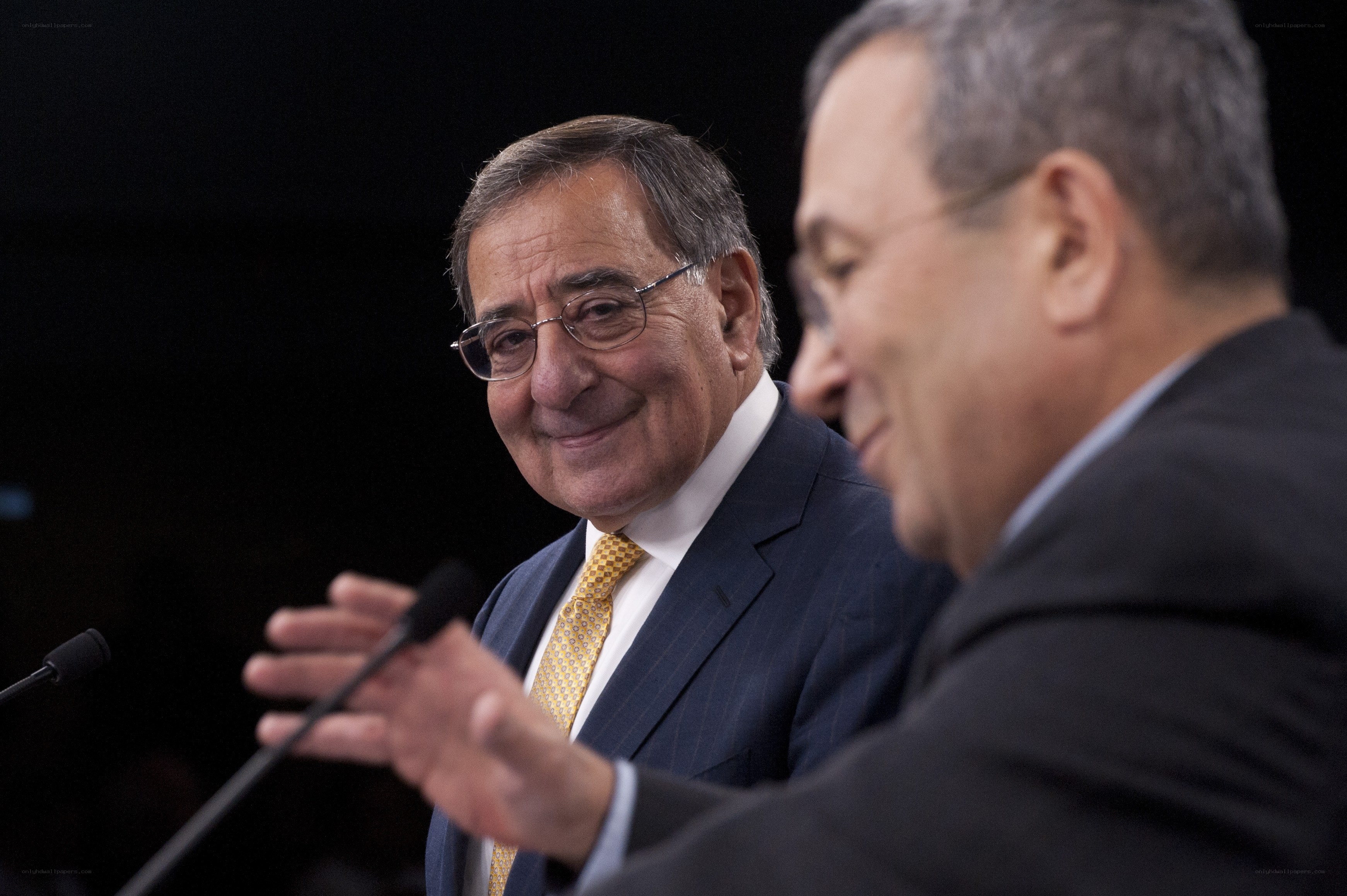 Two men in suits at a conference