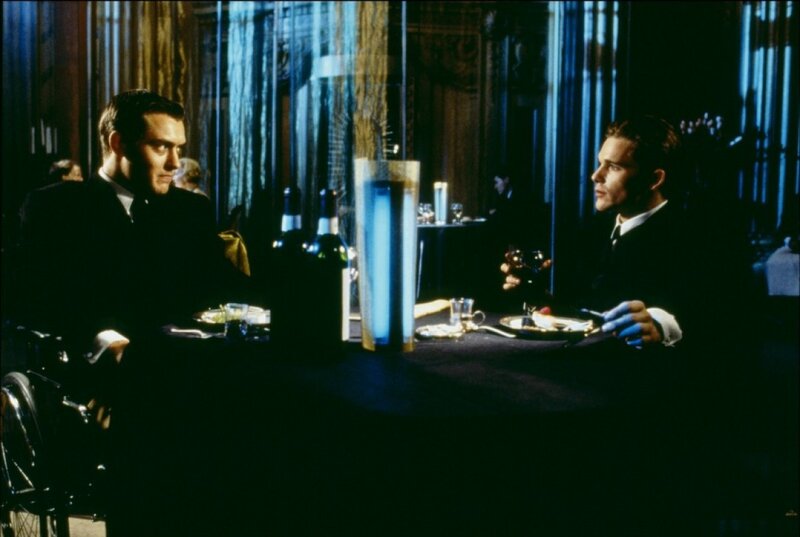 Two men in suits at a dinner table