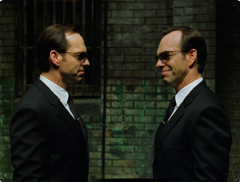 Two men in suits facing each other