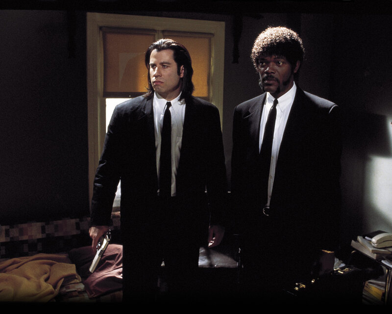 Two men in suits holding guns