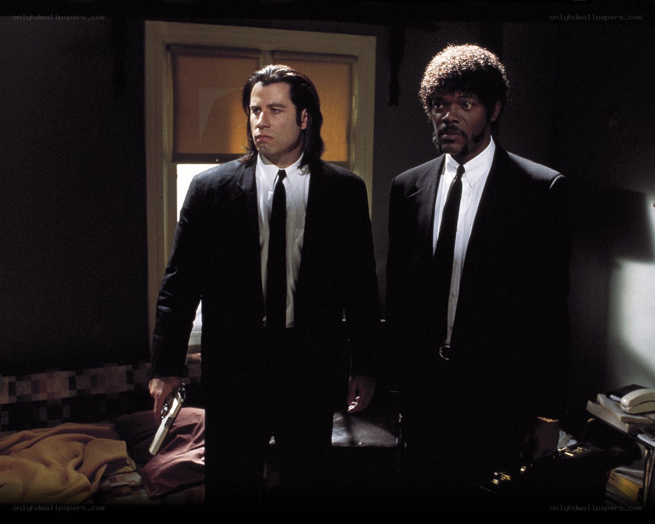 Two men in suits holding guns