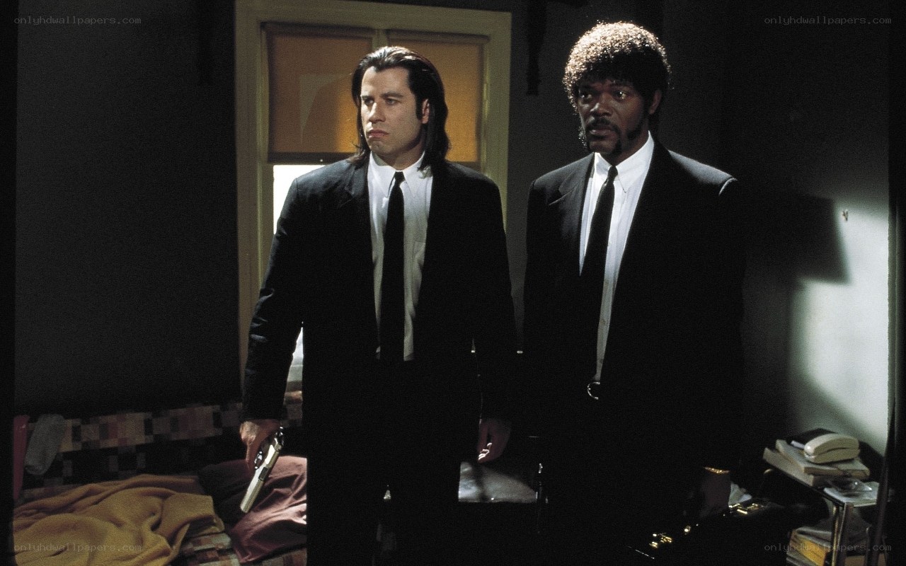 two men in suits holding guns