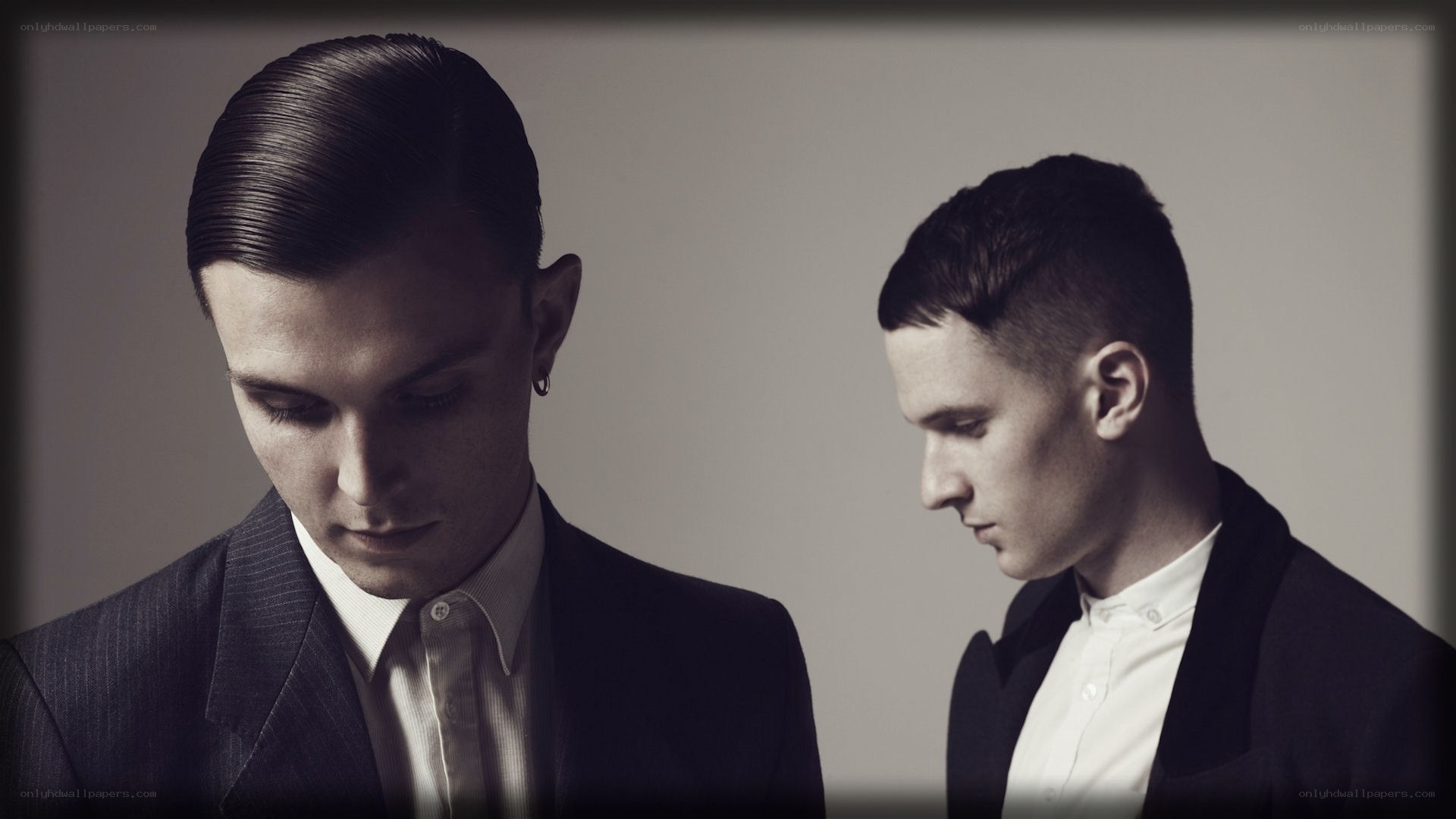 two men in suits looking down