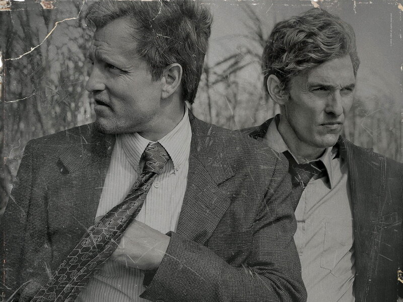 two men in suits looking serious