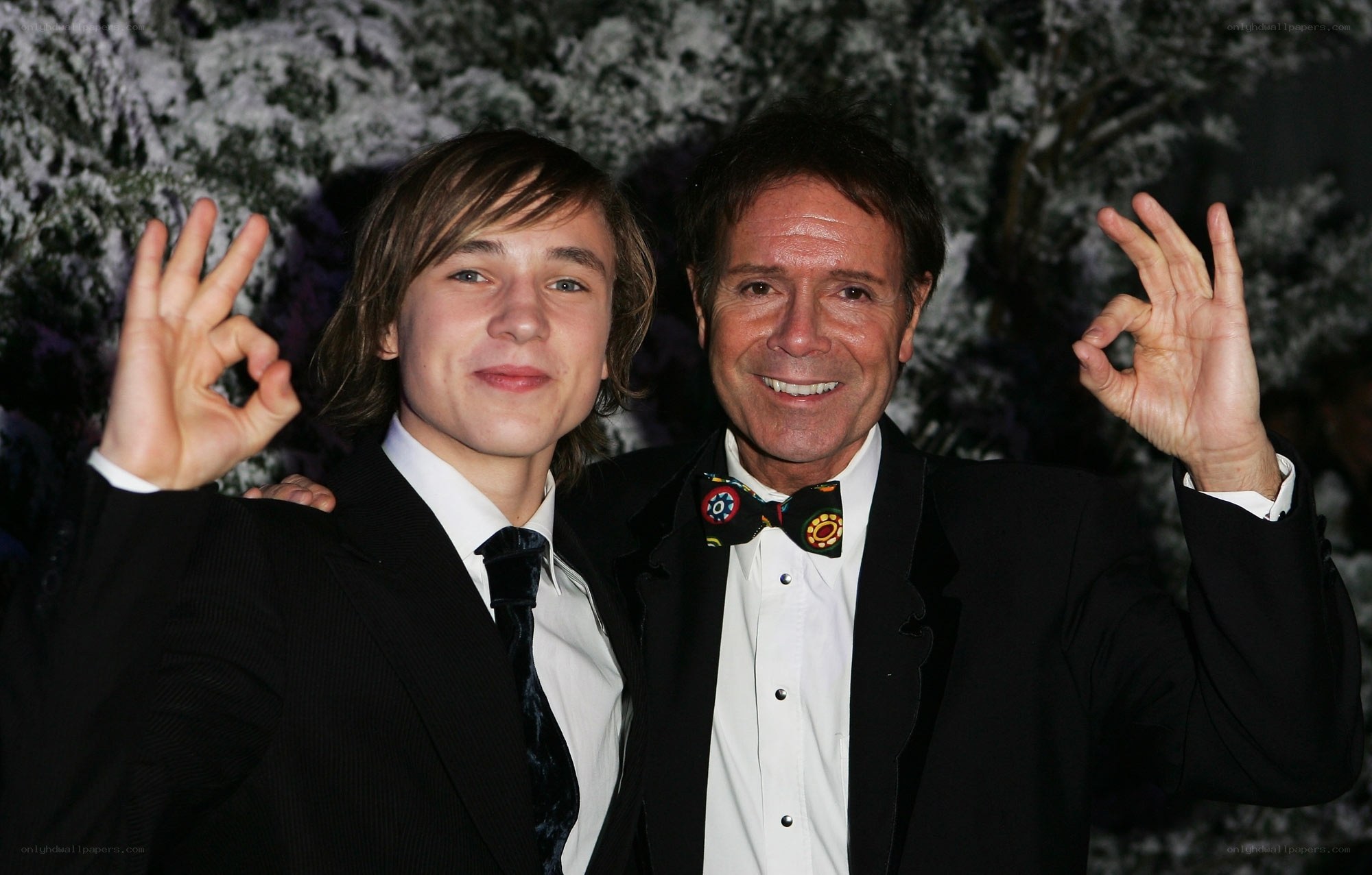 Two men in suits making hand gestures