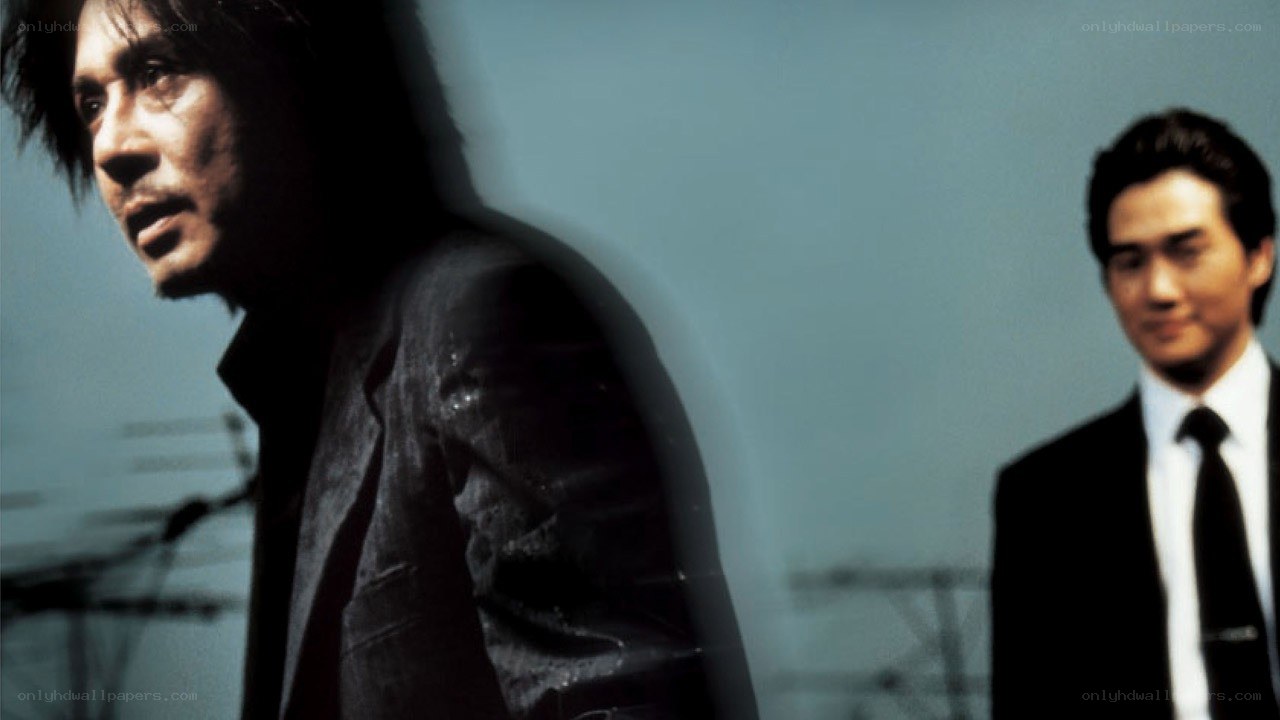 two men in suits on a bridge