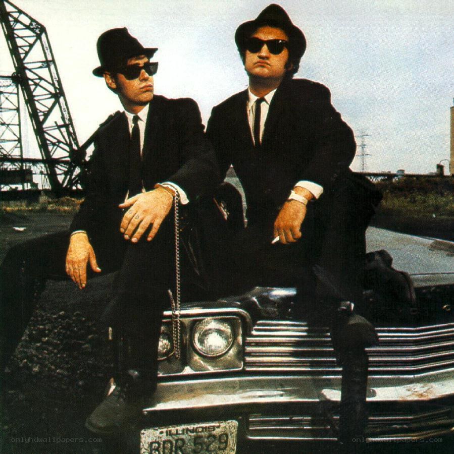 two men in suits on a car