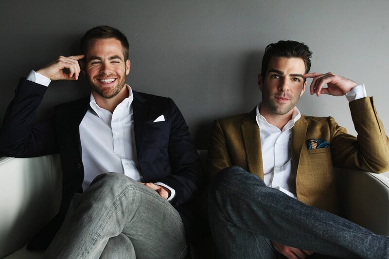 two men in suits on a couch