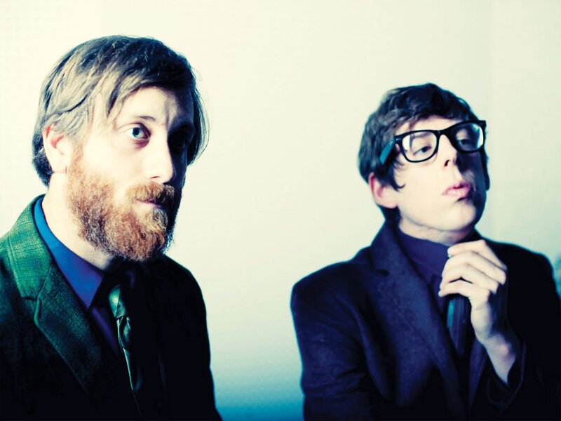 two men in suits posing
