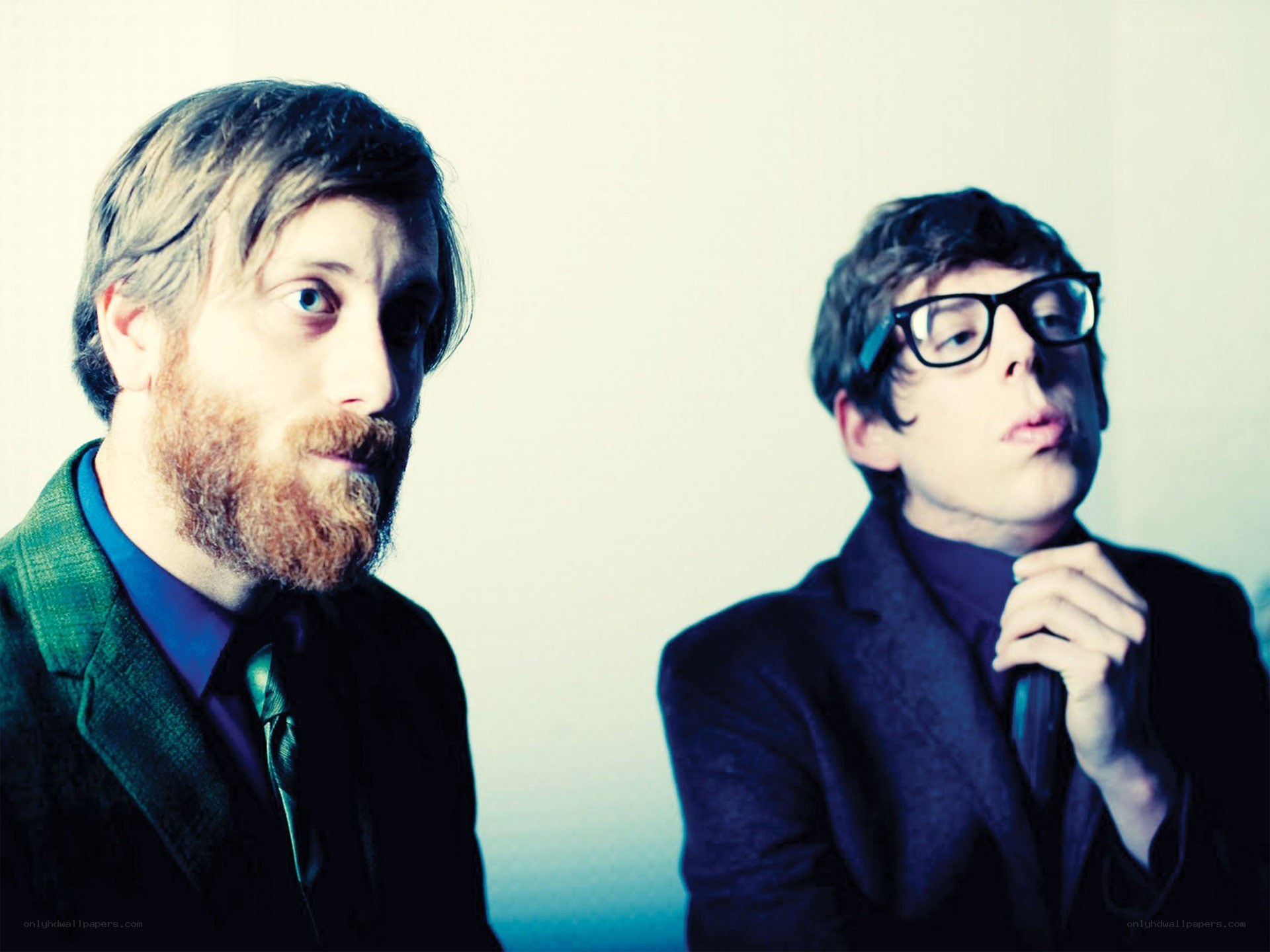 two men in suits posing