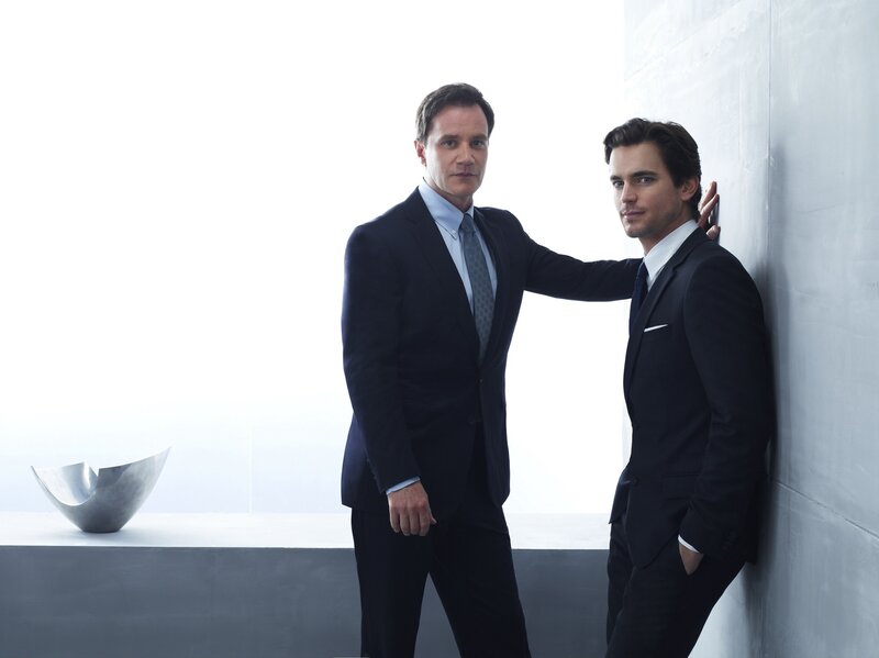 two men in suits posing