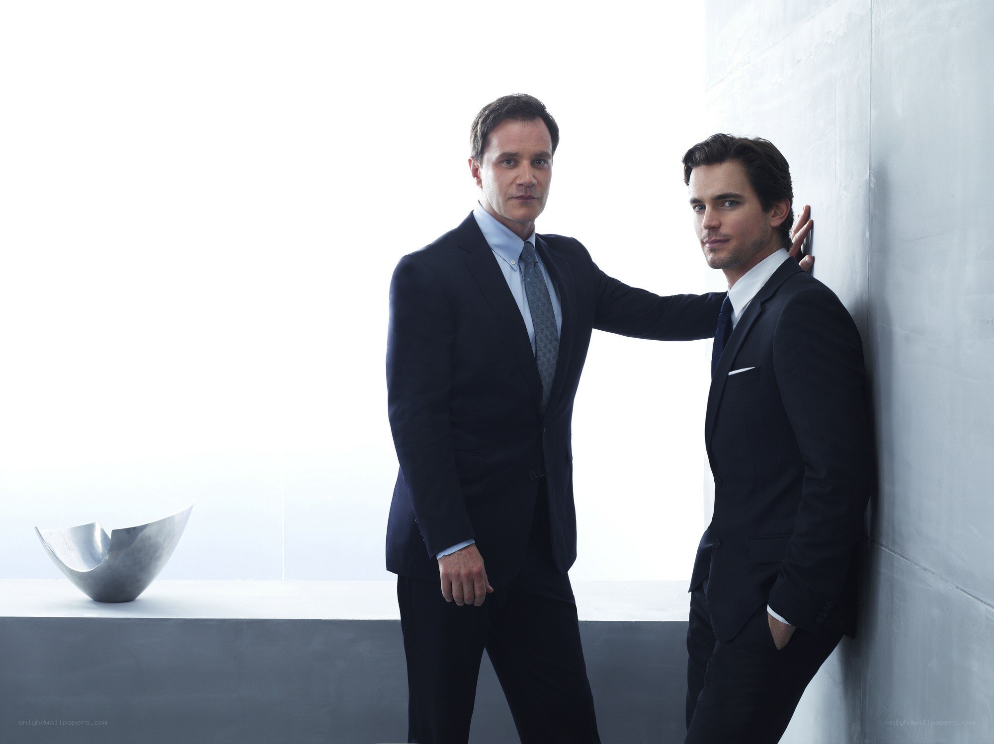 two men in suits posing