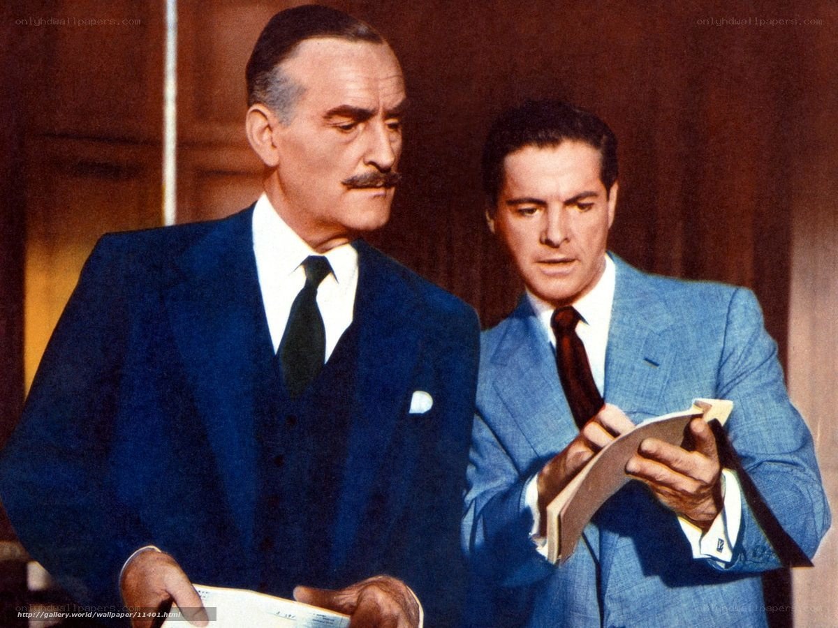 Two men in suits reading documents