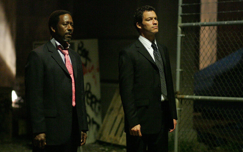 Two men in suits standing at night