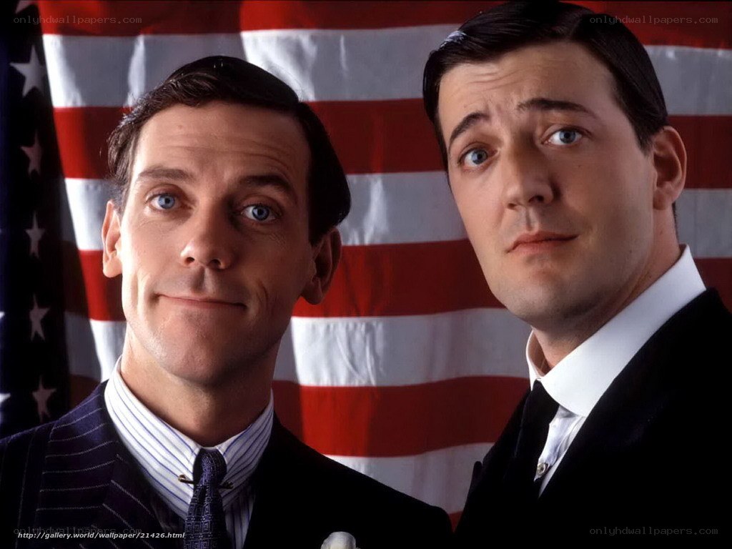 Two men in suits with American flag