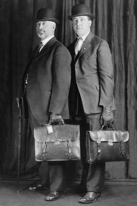 Two men in suits with briefcases