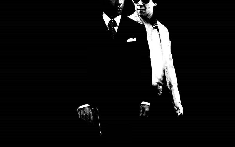 two men in suits with guns