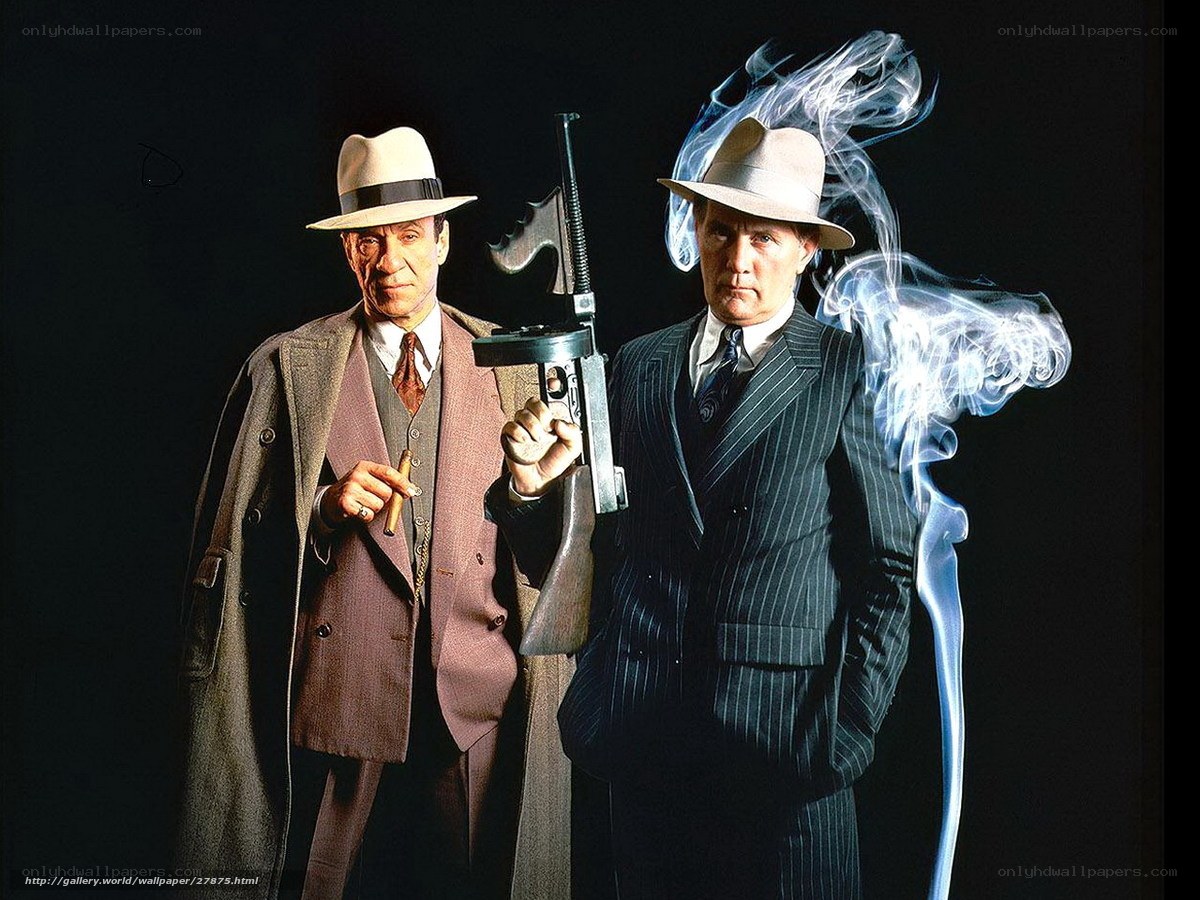 Two men in suits with guns