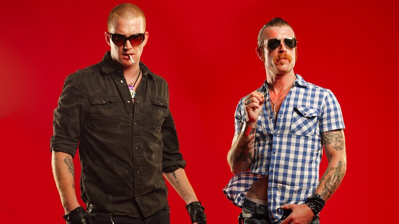 two men in sunglasses on red