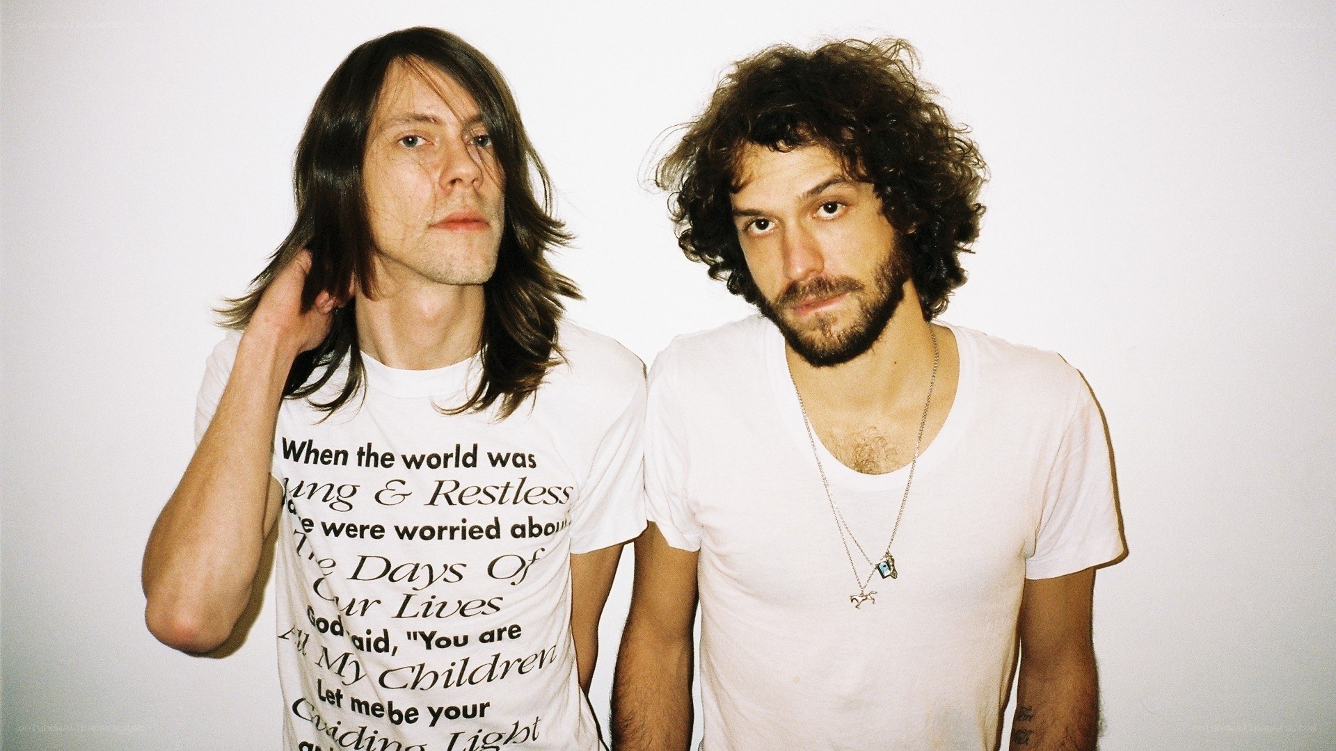 two men in white t-shirts