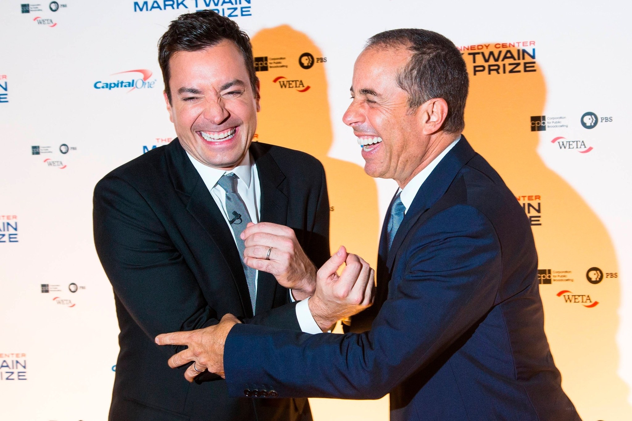 Two men laughing at an event